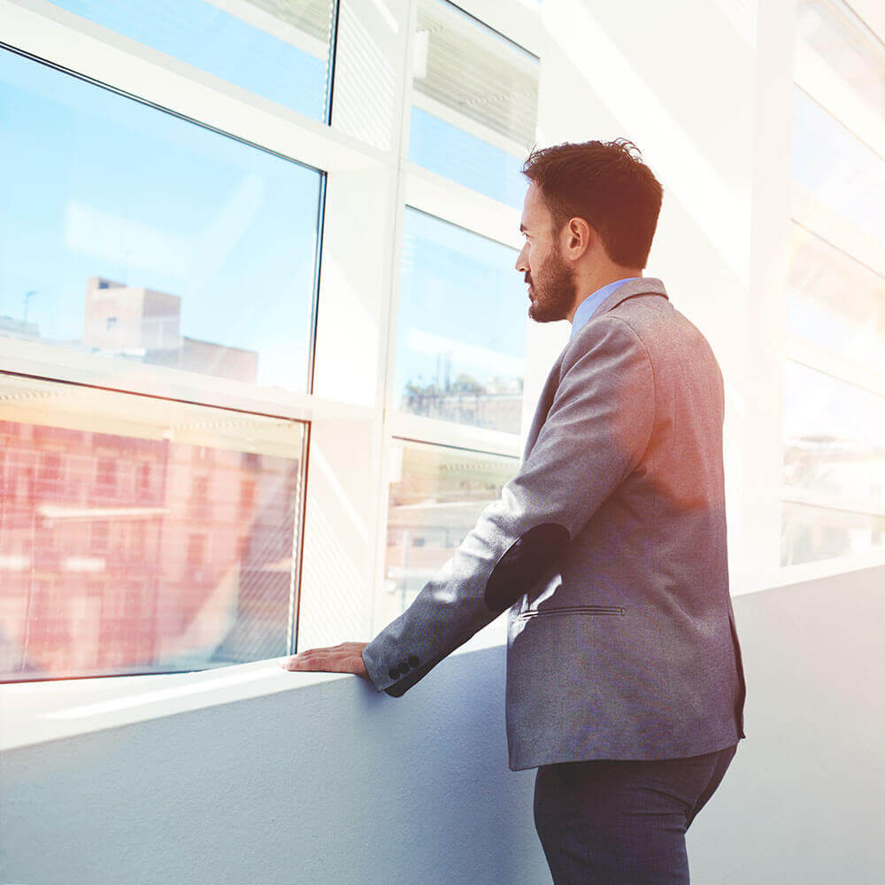 Banker gazing out window