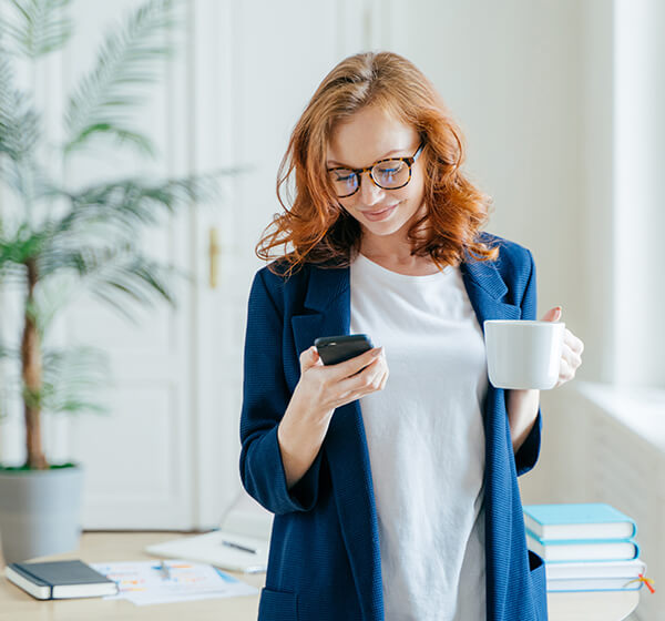 woman wearing gasses looking at phone