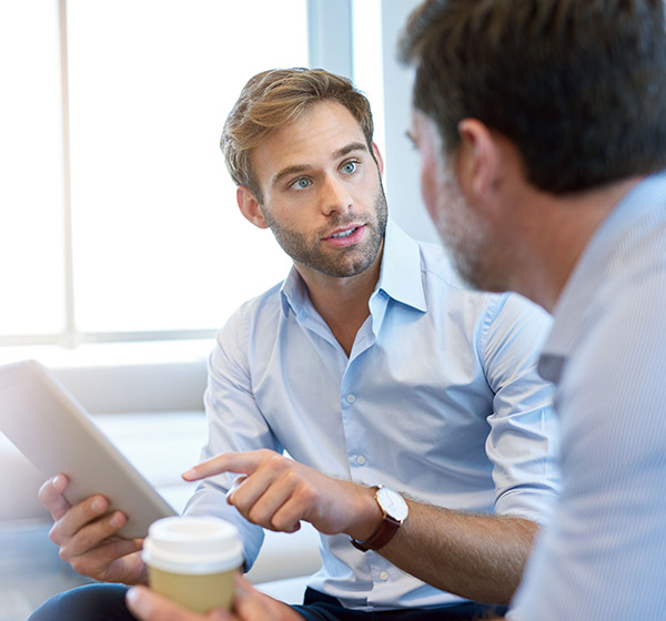 reviewing information on tablet with coworker