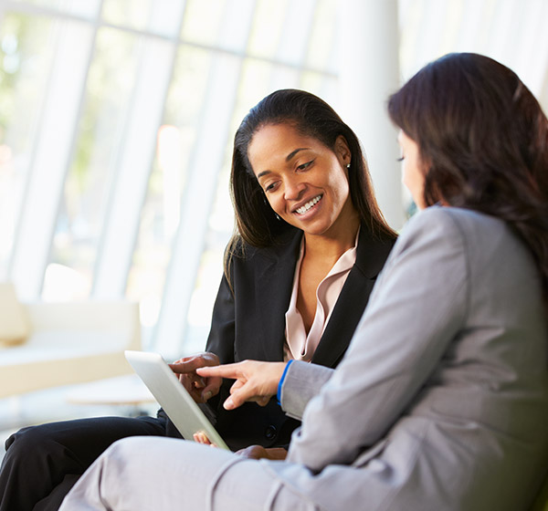 women reviewing tablet